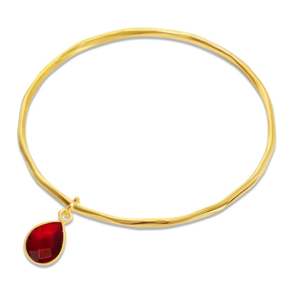 garnet charm bangle in gold on a white background