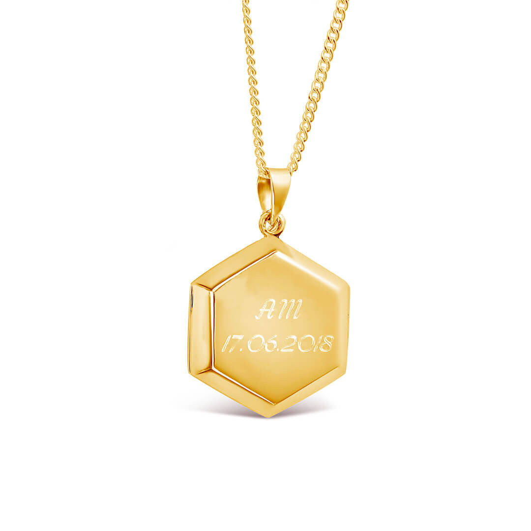 engraved hexagon locket in gold on a white background