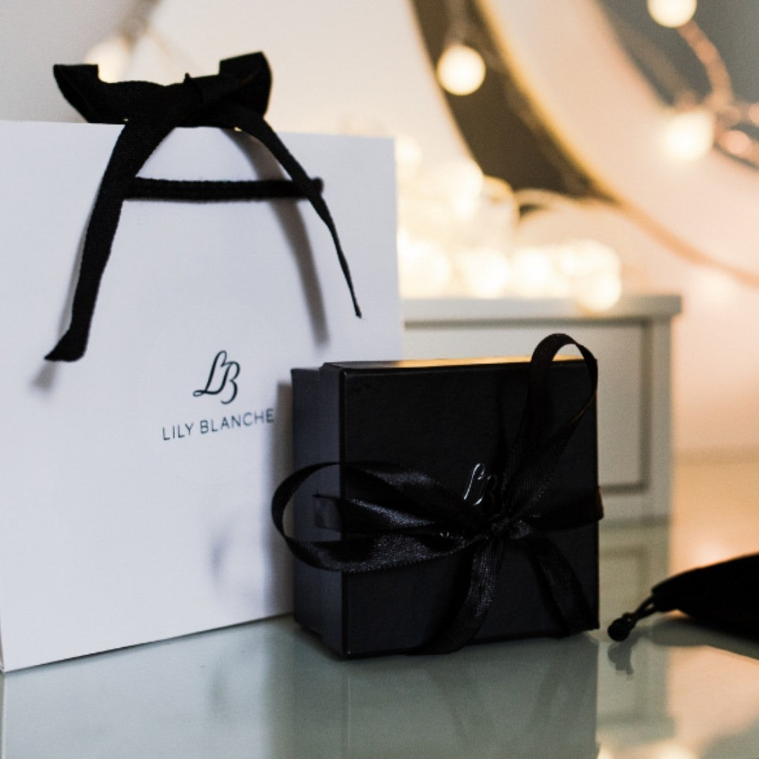 Lily Blanche gift box, giftbag and anti-tarnish bag sitting on a vanity table