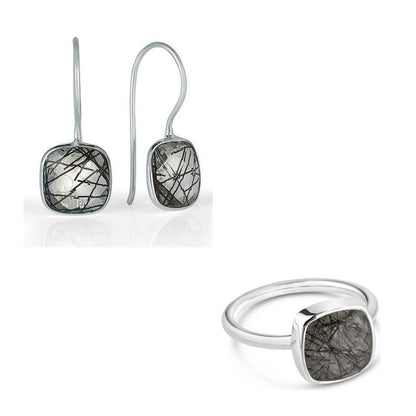 rutilated quartz cocktail ring in silver with matching earrings on a white background