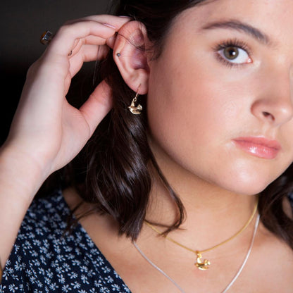 model wearing bird earrings in silver