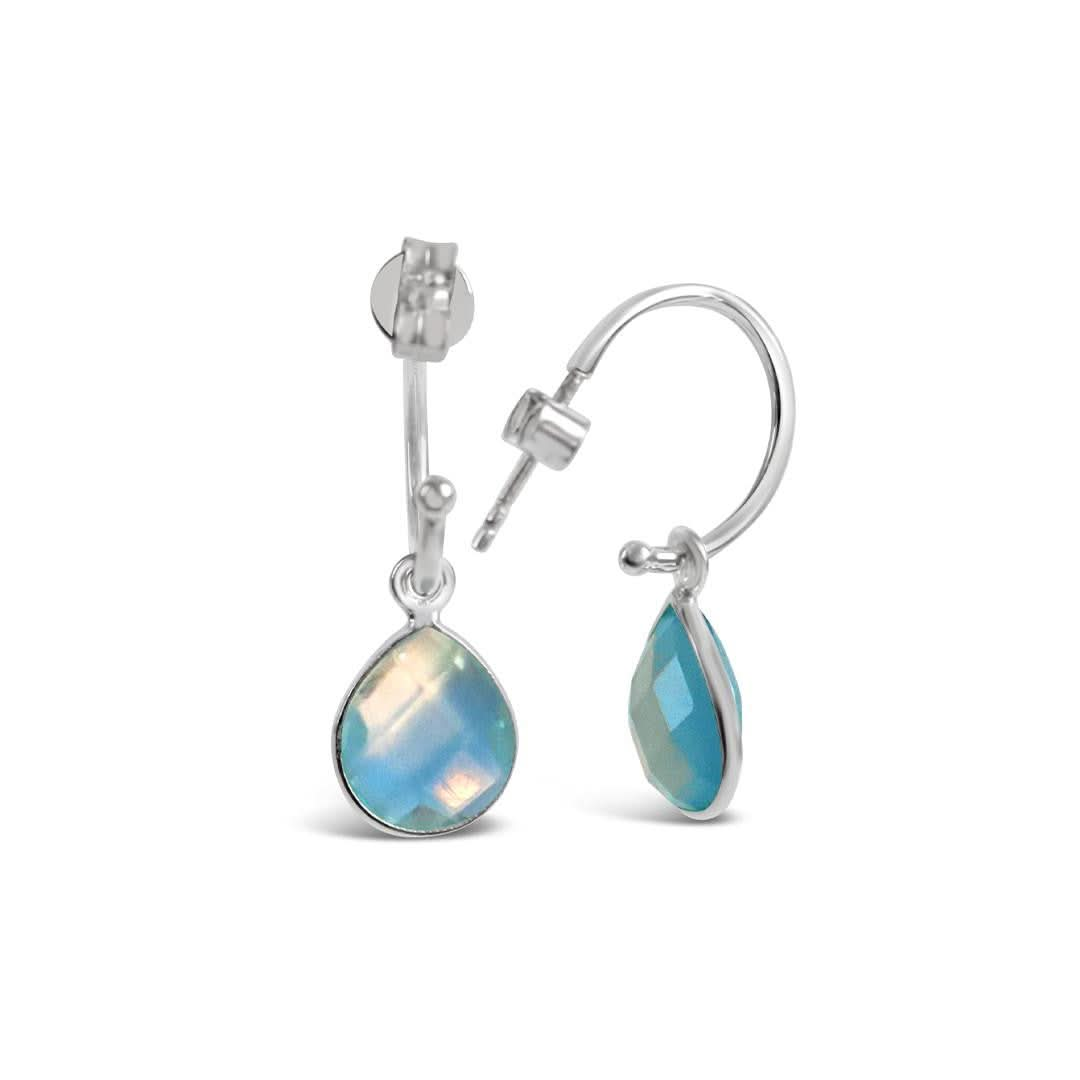 blue topaz drop hoop earrings in silver on a white background