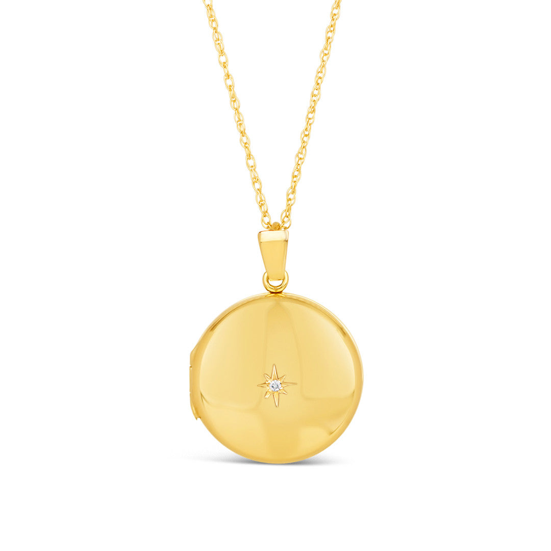 round diamond locket in gold with family photos inside