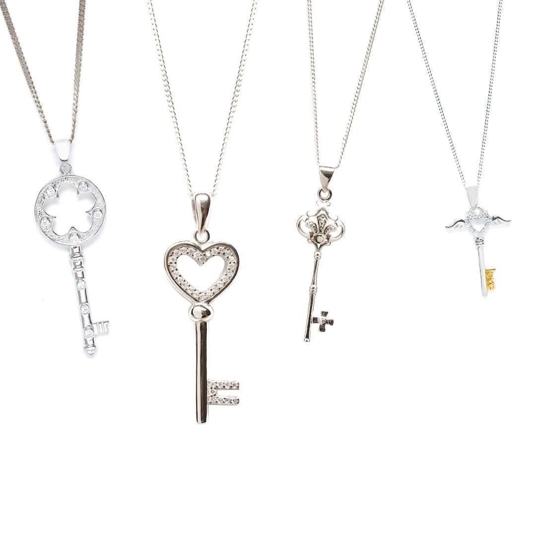 collection of key shaped jewellery on a white background