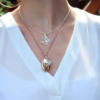 model wearing butterfly pendant in silver 