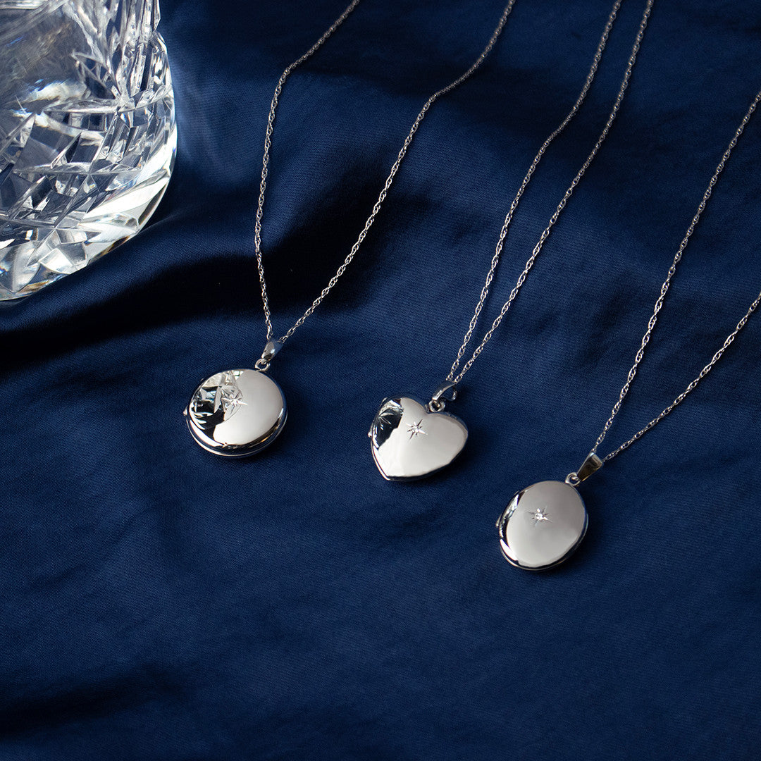 small diamond heart, round and oval lockets in white gold on a white background
