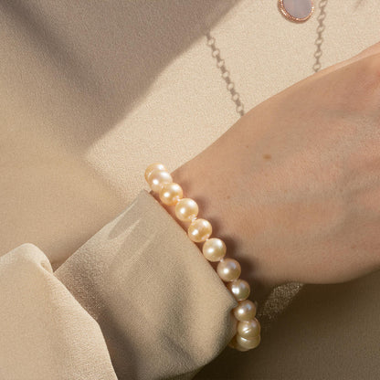 close up of model wearing classic pearl bracelet in champagne 