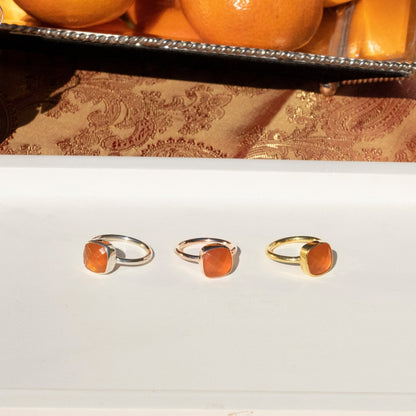 three carnelian cocktail rings on a white platter