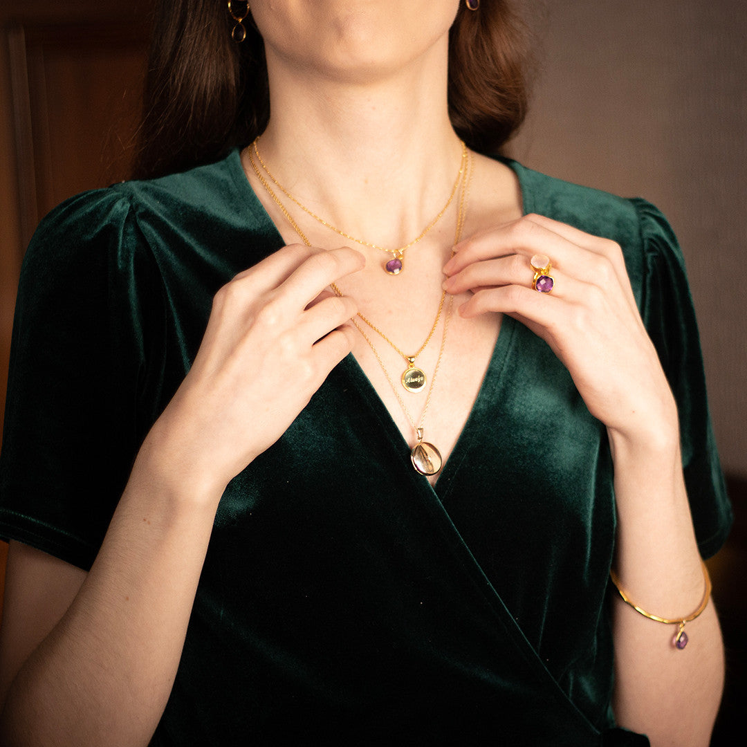 model wearing round diamond heart locket in gold