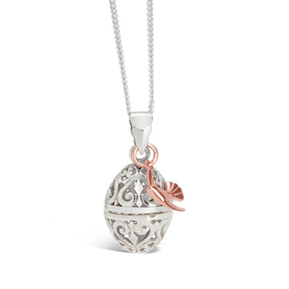 silver bird locket with rose gold bird charm on a white background