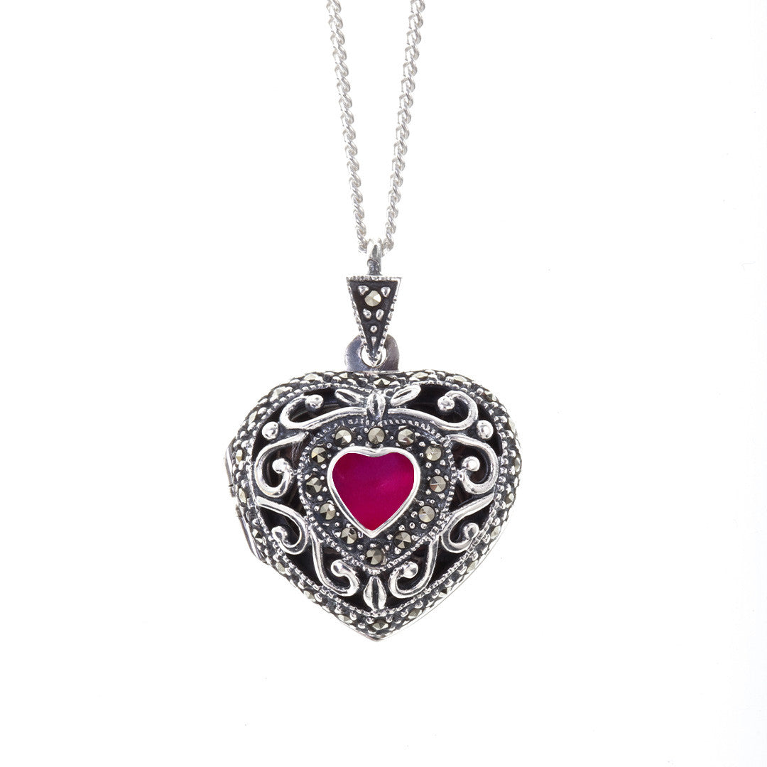 ruby vintage heart locket in silver on a white background