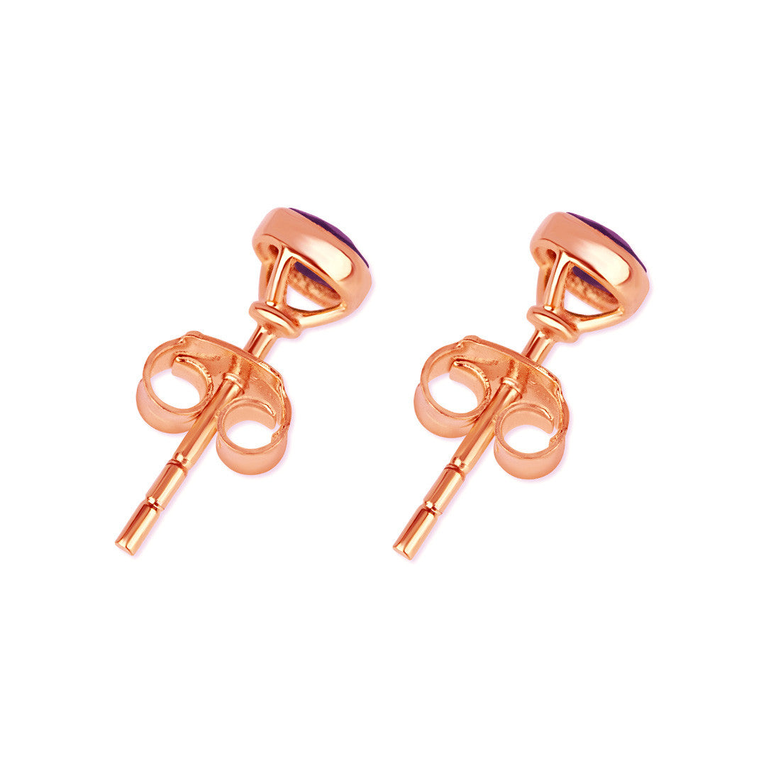 Blue topaz mini stud earrings in rose gold facing the back on a white background