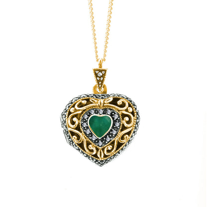 emerald vintage heart locket in gold on a white background