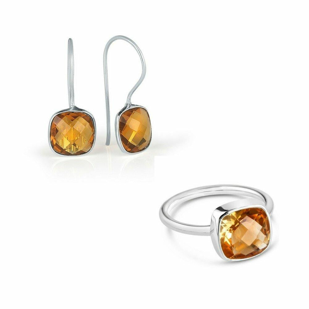 citrine earrings and cocktail ring in silver on a white background