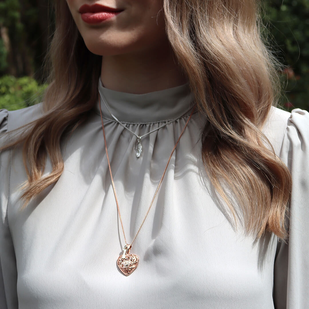 model wearing heart locket in rose gold