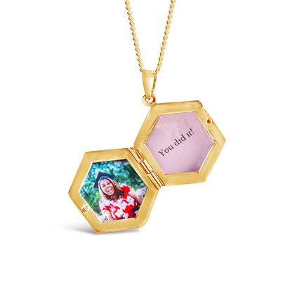 opened hexagon shaped locket in gold with photos inside