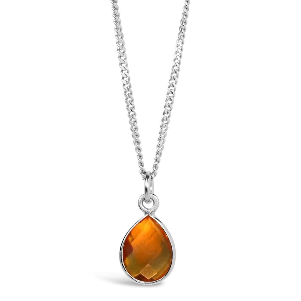 citrine charm necklace in silver on a white background