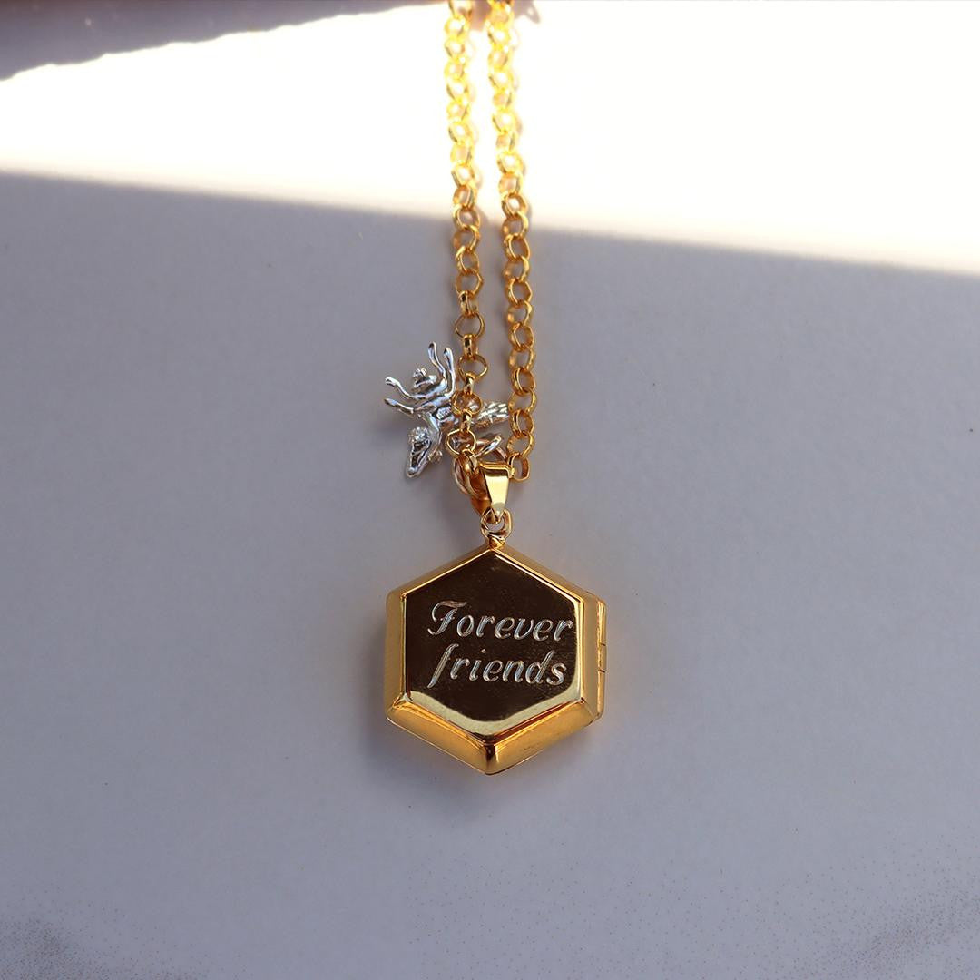 bee locket in gold with silver bee charm and engraved message on locket