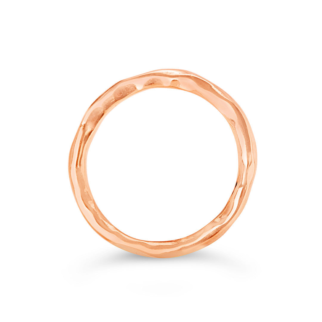 men's hammered ring in rose gold on a white background