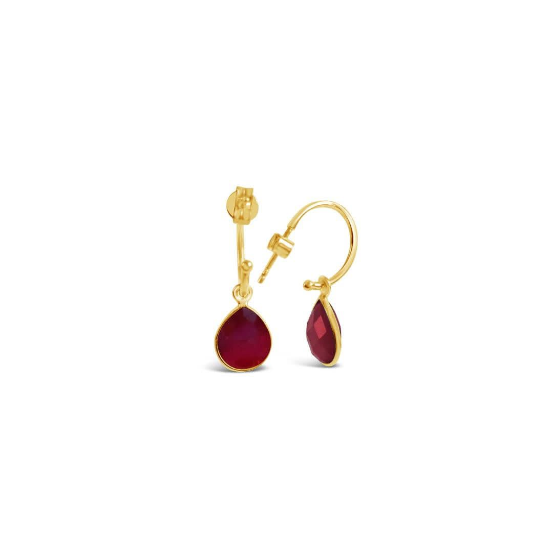 garnet drop hoop earrings in gold on a white background