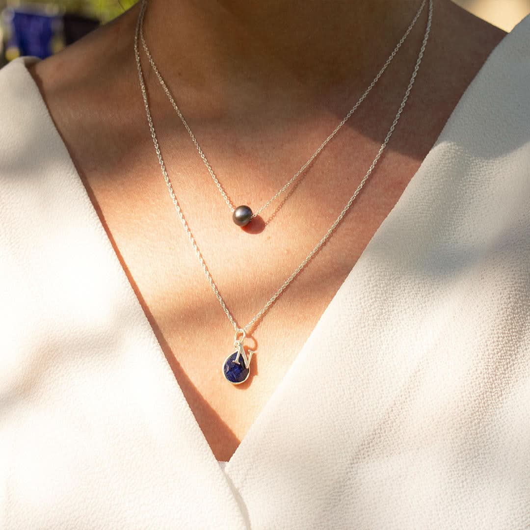 model wearing pearl chain necklace in grey with silver chain