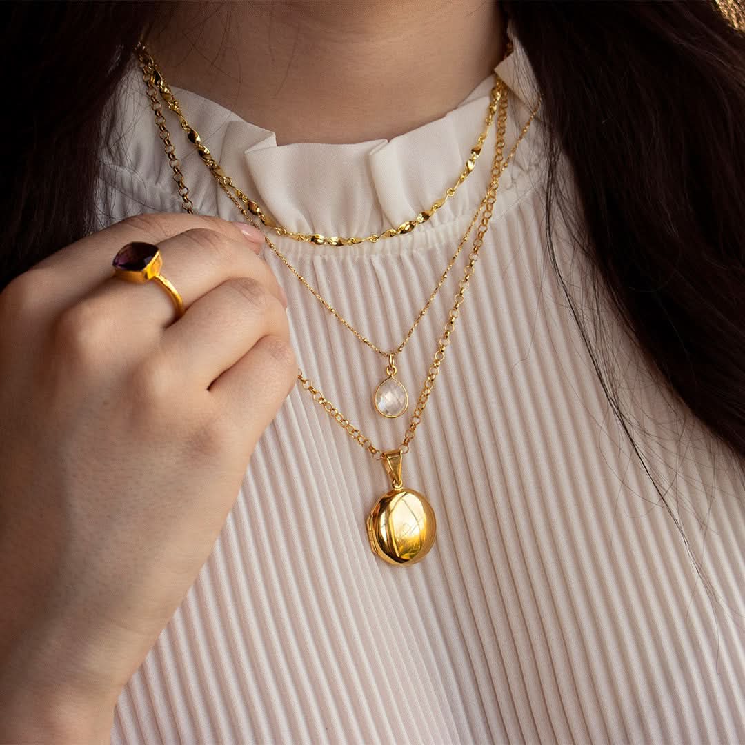 model wearing gold feather locket