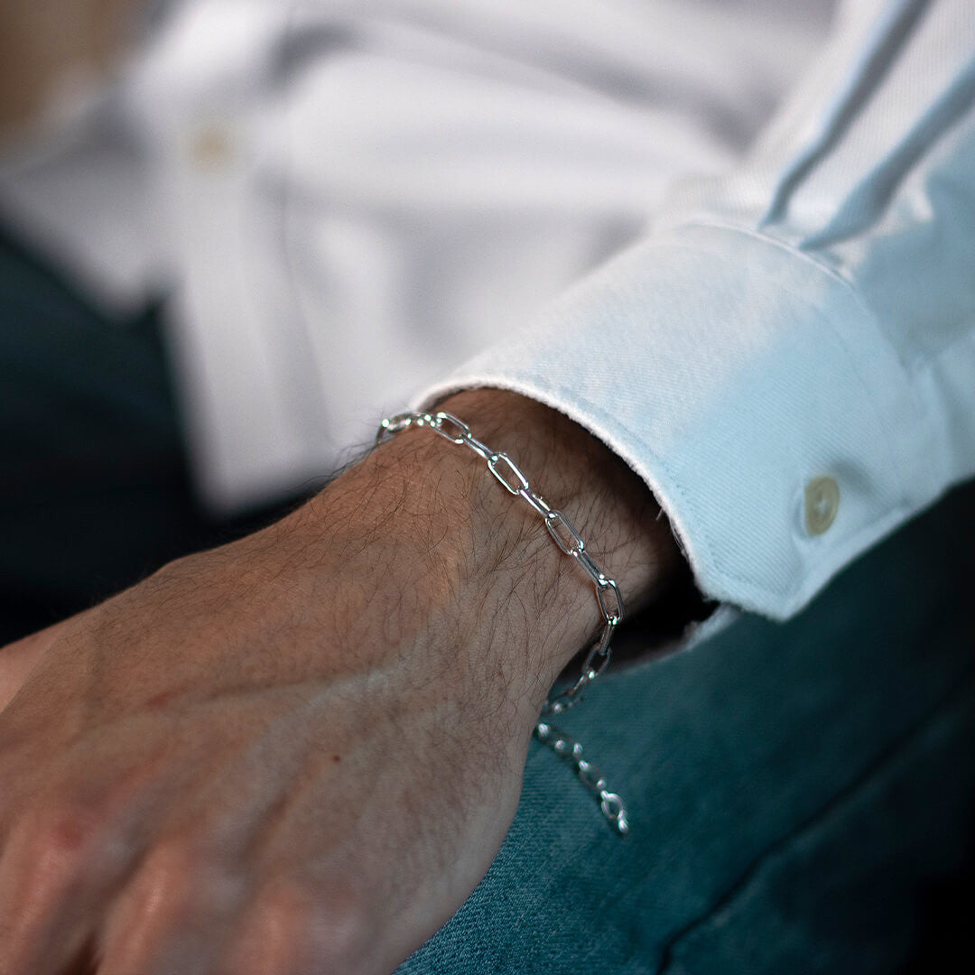 model wearing men's paperclip chain bracelet in silver