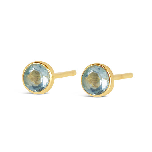 Blue topaz mini stud earrings in gold facing the front on a white background