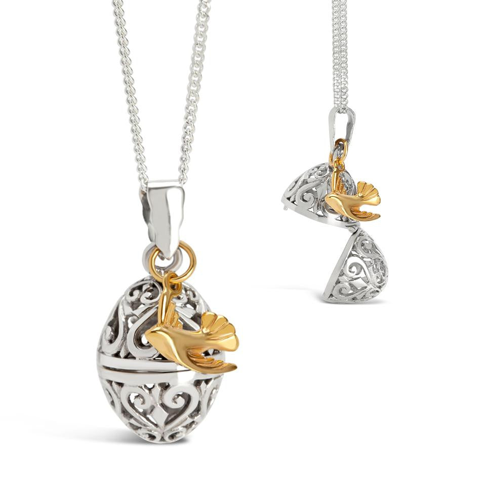bird locket in silver with gold bird charm on a white background
