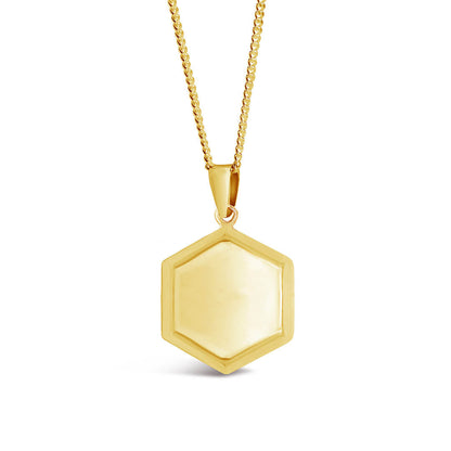 hexagon shaped locket in gold from the front on a white background