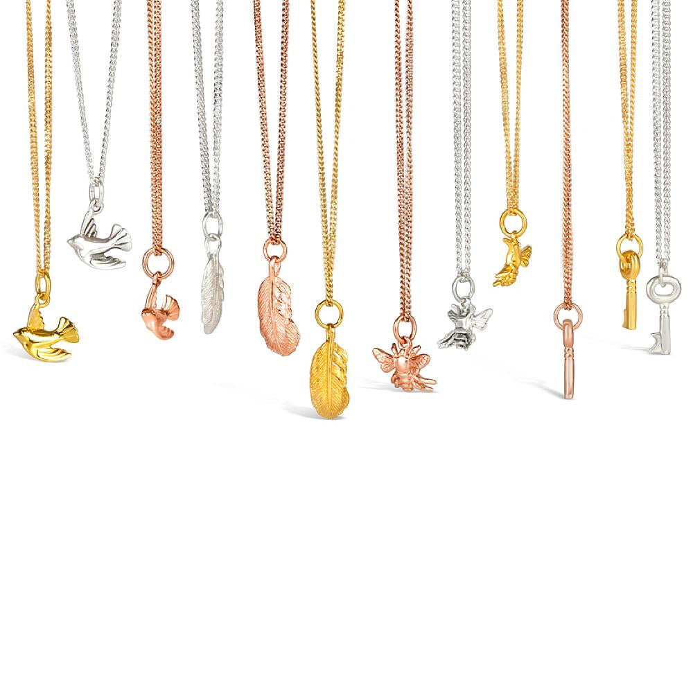 collection of charm necklaces on a white background