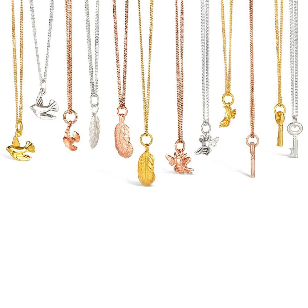 collection of charm necklaces on a white background