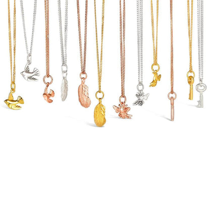 collection of charm necklaces on a white background