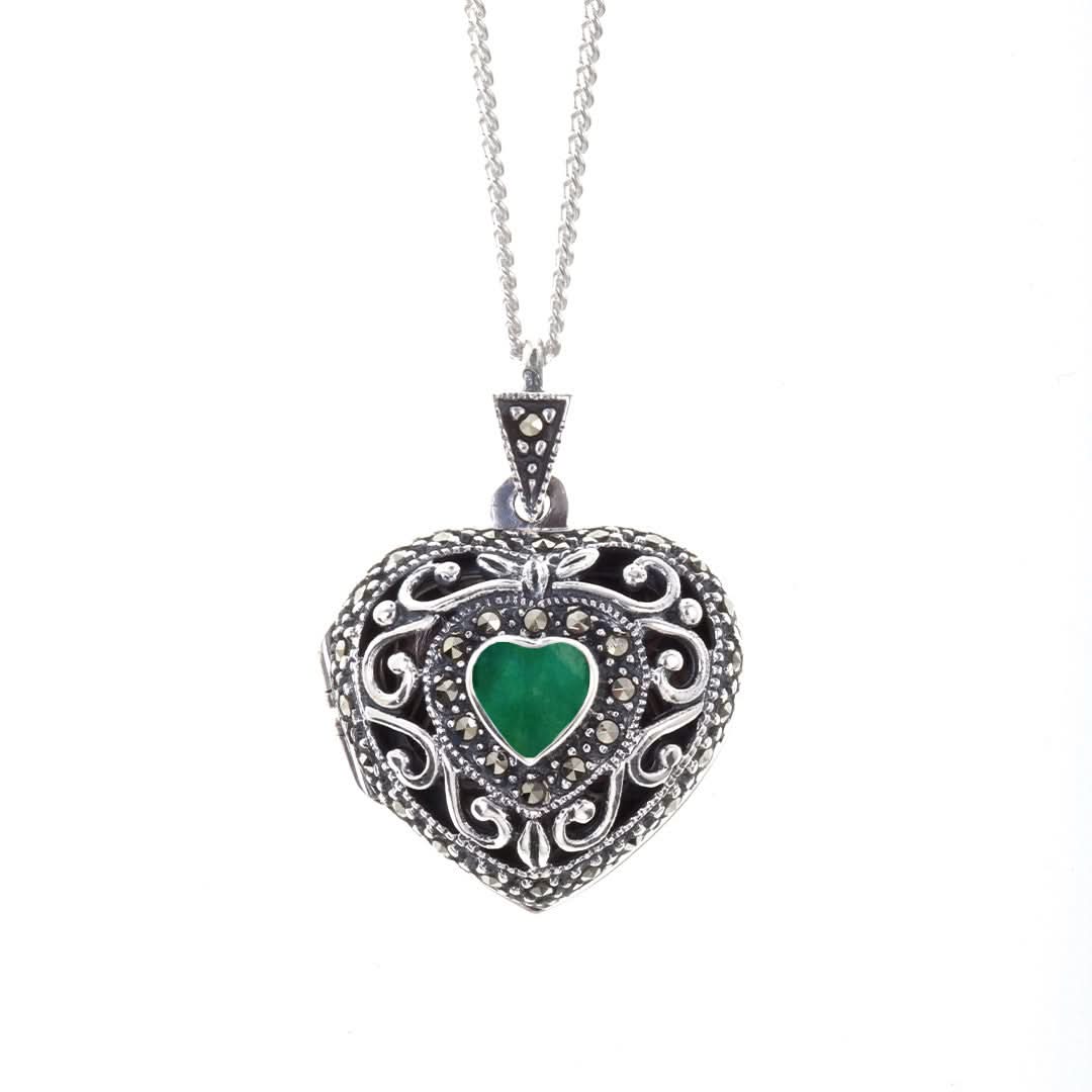 emerald vintage heart locket in silver on a white background