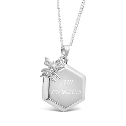 engraved bee locket in silver with charm on  white background