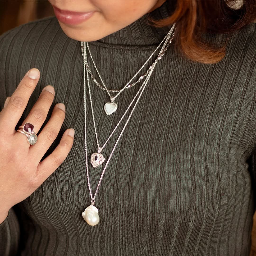 model wearing engravable heart necklace in silver