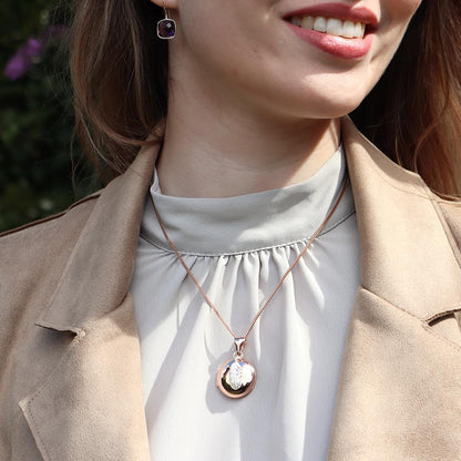 model wearing rose gold feather locket with silver feather charm