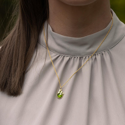 model wearing gold rope chain with gold peridot birthstone charm and initial