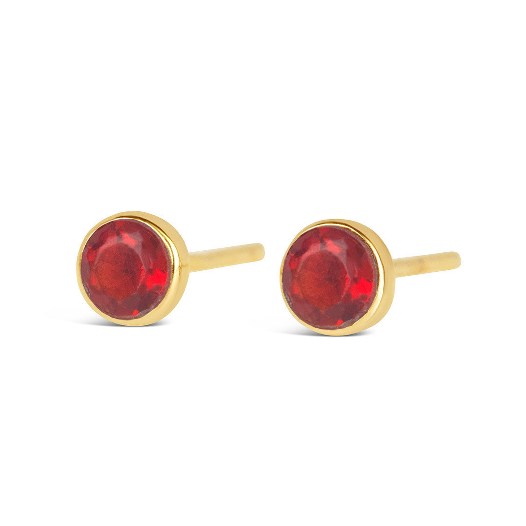 Garnet mini stud earrings in gold facing the front on a white background