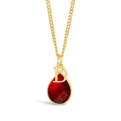 garnet charm necklace in gold with initial charm on a white background