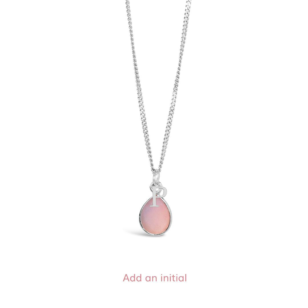 pink opal charm necklace in silver with initial charm on a white background