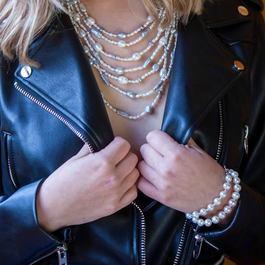 model wearing two classic pearl bracelets 