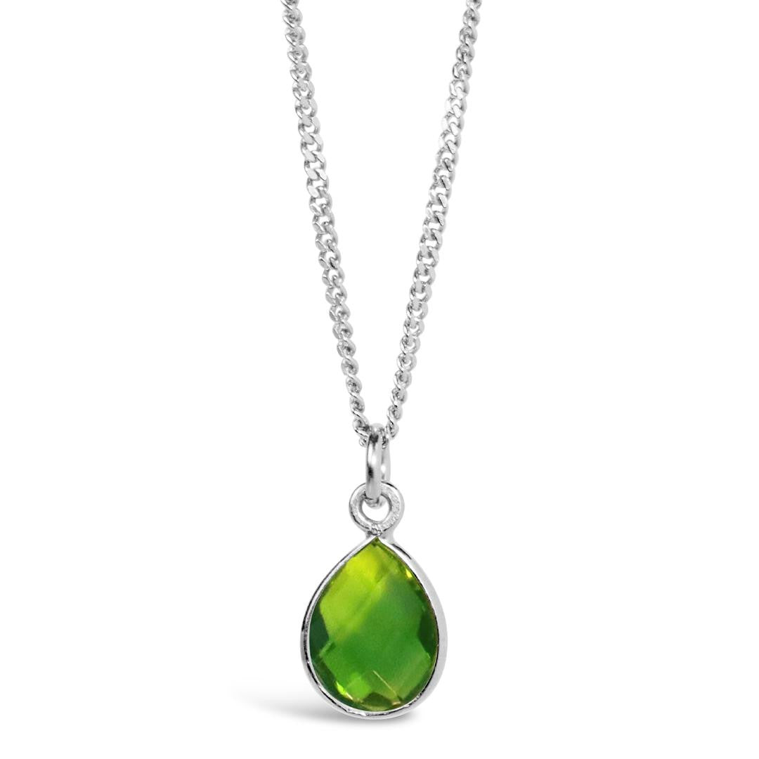 peridot charm necklace in silver on a white background