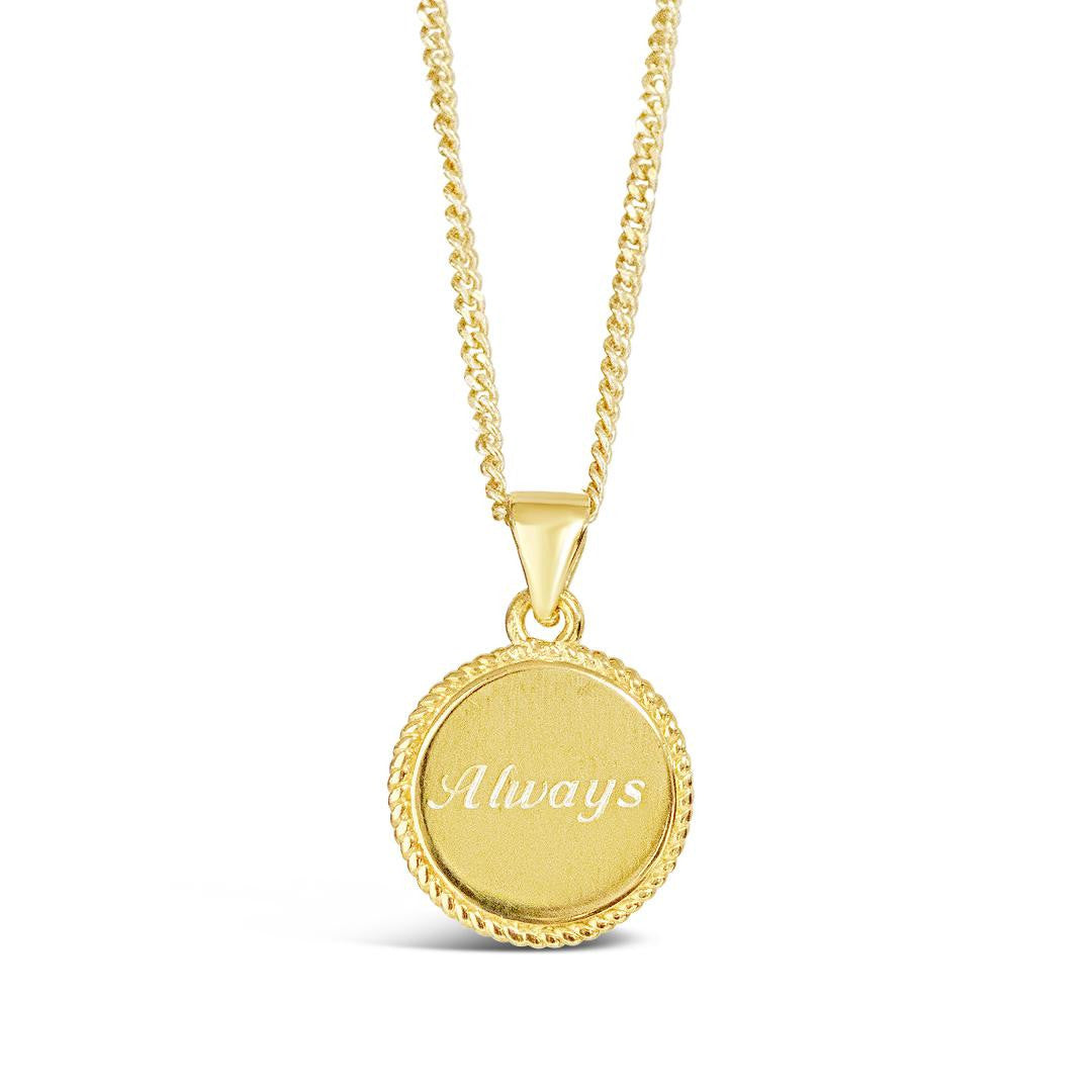 disc necklace engraved with message on a white background