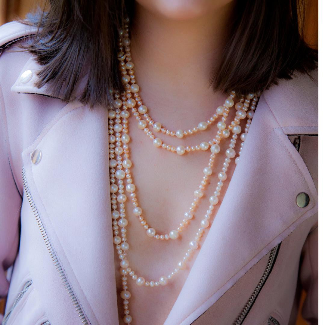 model wearing eternal pearl necklace in champagne 