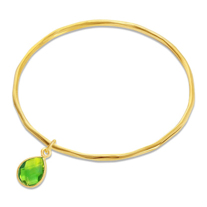 real green peridot teardrop gemstone on a gold thin bangle