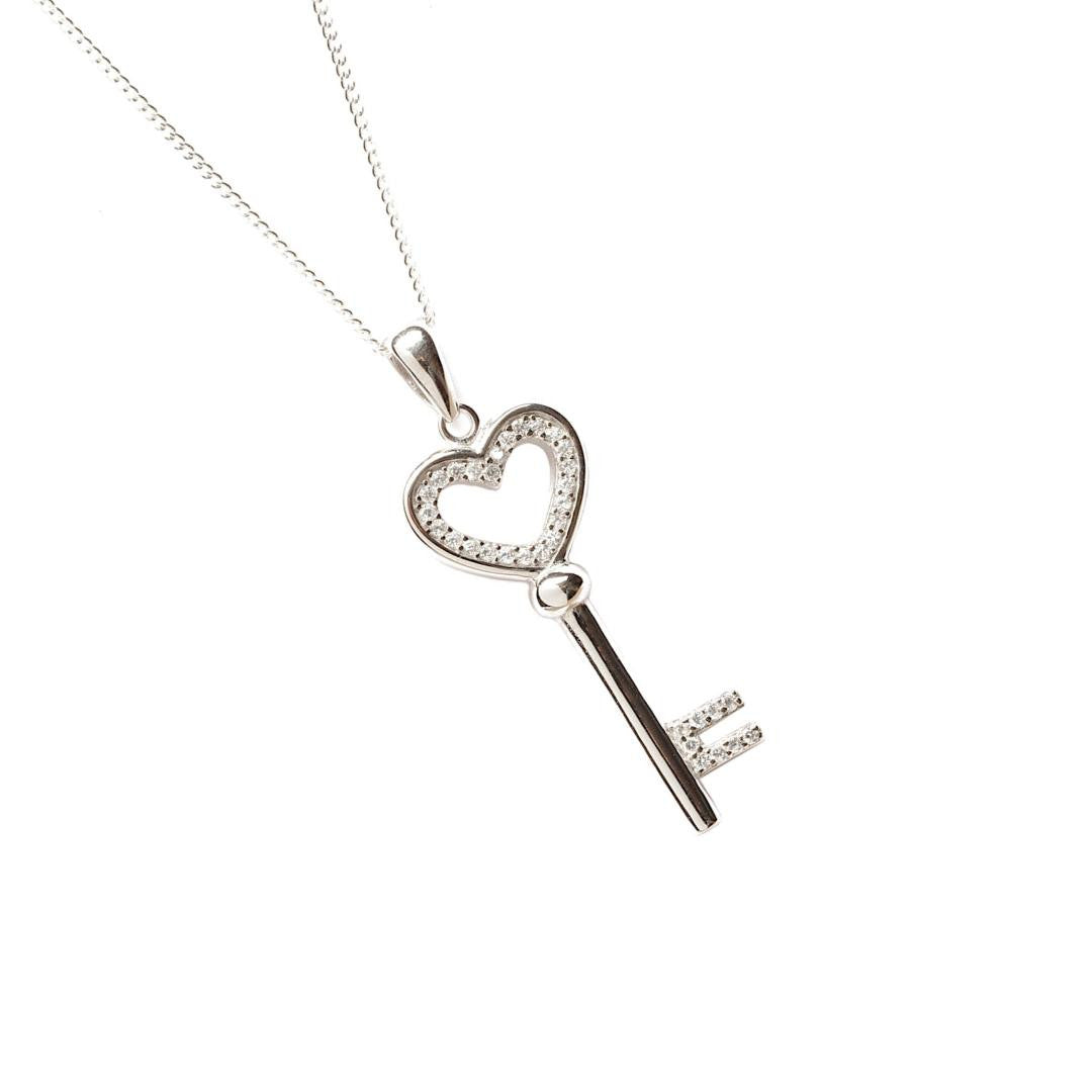 love key pendant in silver on a white background