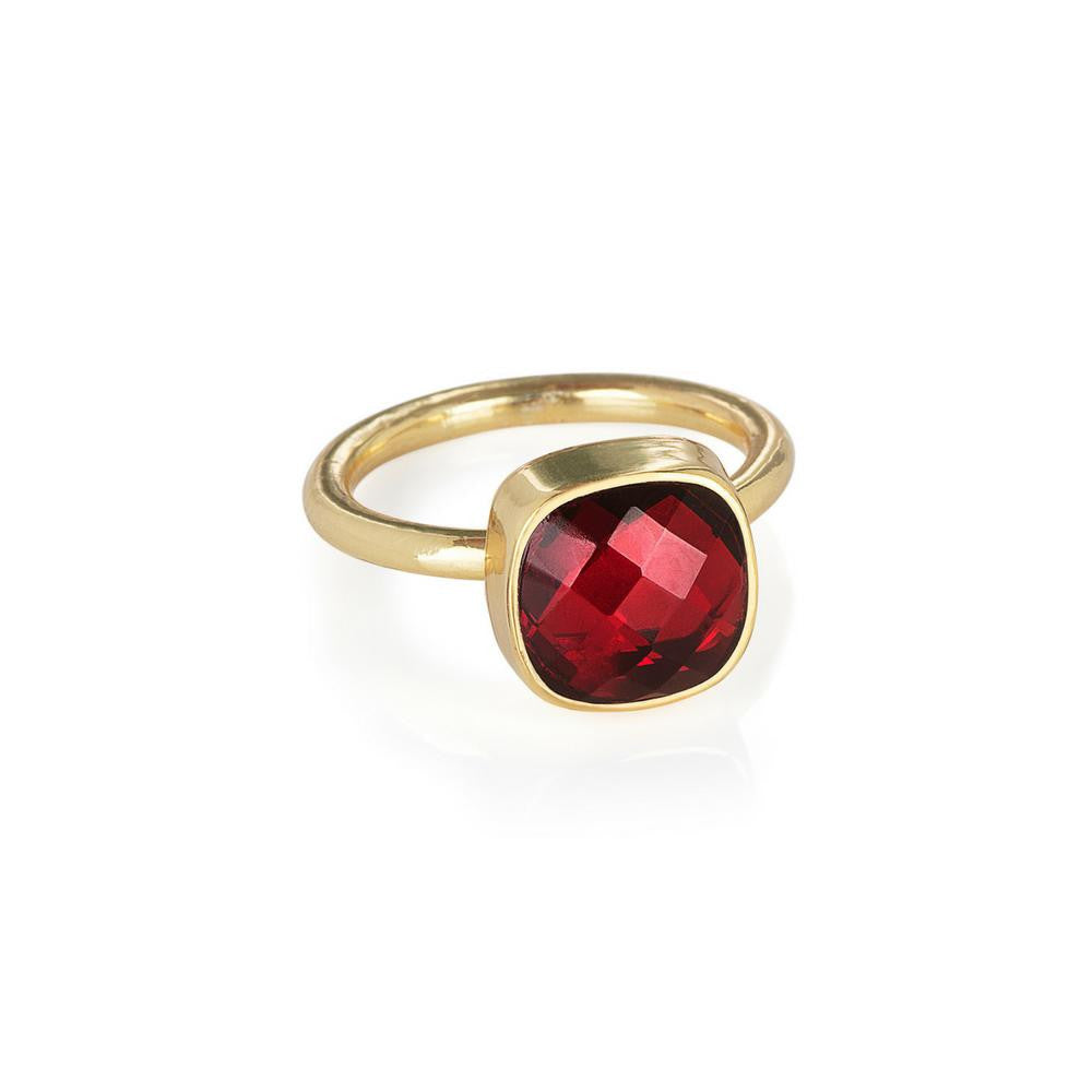 garnet cocktail ring in gold on a white background 