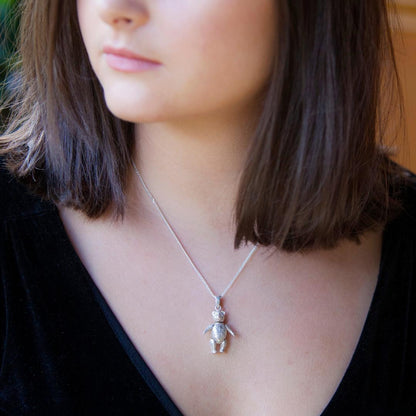 Model wearing large sterling silver teddy bear pendant on silver curb chain