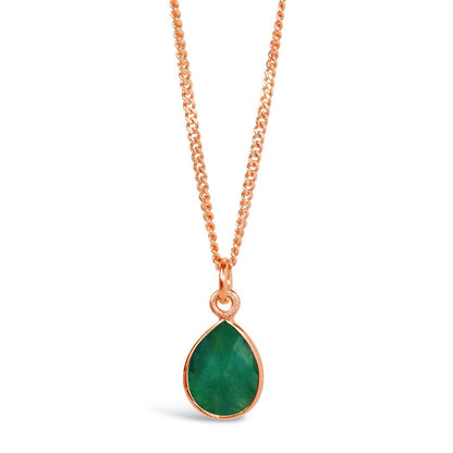 emerald charm necklace in rose gold on a white background